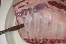 Knife Under the Membrane or Fell of a slab of spare ribs