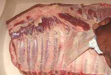 The Membrane or Fell Being Removed From Spare Ribs